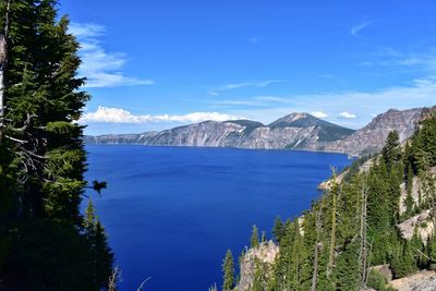 Scenic view of bay against blue sky