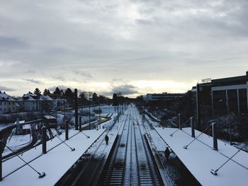 Railroad tracks against sky during winter