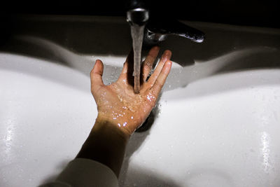 Midsection of woman in water at night