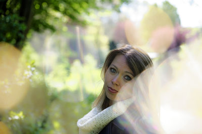 Portrait of young woman looking away outdoors