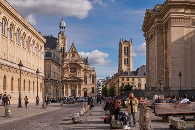 Group of people in front of buildings in city