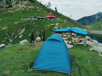 Scenic view of tent on land against mountains