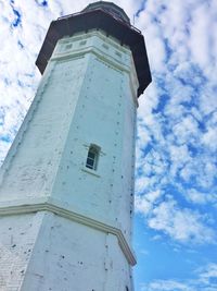 Low angle view of tower against cloudy sky