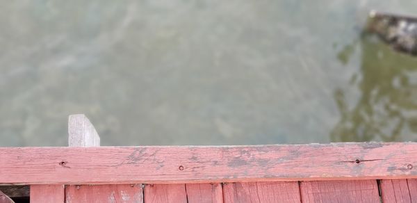 Close-up of pier against lake