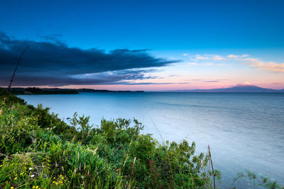 Scenic view of sea against sky at sunset