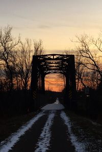 Silhouette bridge against sky during winter