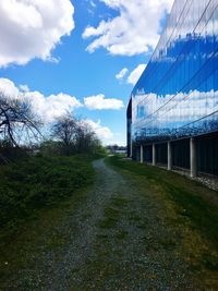 Building on field against sky