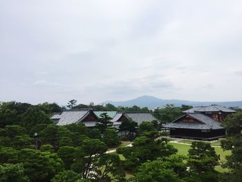 High angle view of houses and trees against sky