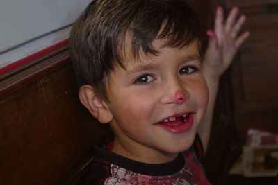 Portrait of happy boy with blood on nose