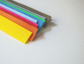 High angle view of multi colored pencils on white background