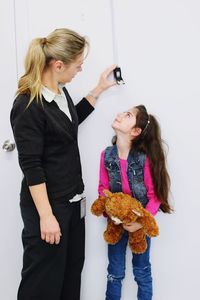 Young woman standing against the wall