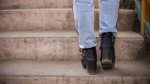 Low section of man standing on staircase