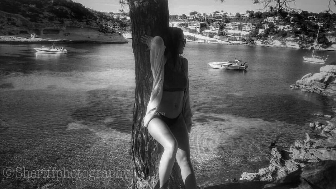 tree, water, nature, one person, beauty, leisure activity, young adult, women, sea, adults only, outdoors, young women, beauty in nature, day, only women, people, real people, adult, nautical vessel, beautiful woman, one woman only, one young woman only