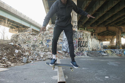 A young man skateboarding.