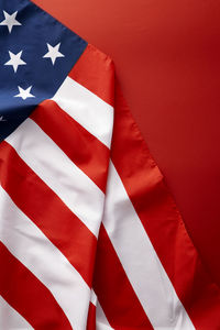 Close-up of flag against red wall