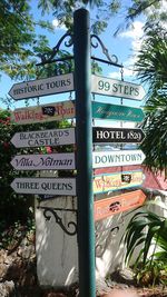 Low angle view of information sign against sky