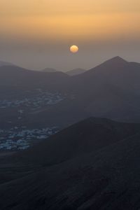 Scenic view of mountains against sky during sunset