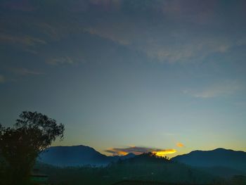 Scenic view of silhouette mountains against sky during sunset