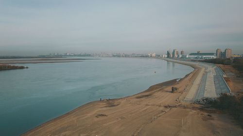 Panoramic view of sea and city against sky