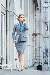 Full length of a young woman using mobile phone