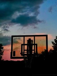 Silhouette man standing by plants against sky during sunset