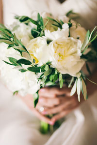 Midsection of woman holding flower bouquet