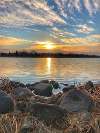 Scenic view of lake against sky during sunset