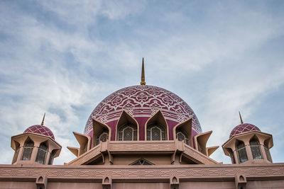 Low angle view of a building against cloudy sky