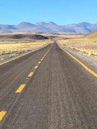 Empty road along countryside landscape