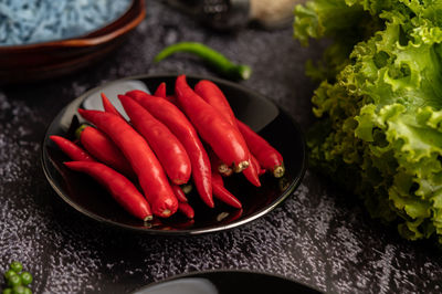 High angle view of red chili peppers in plate on table