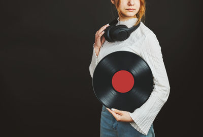 Woman holding vinyl record. music passion. listening to music from analog record. dj playing music