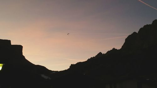 Low angle view of silhouette mountain against sky at sunset