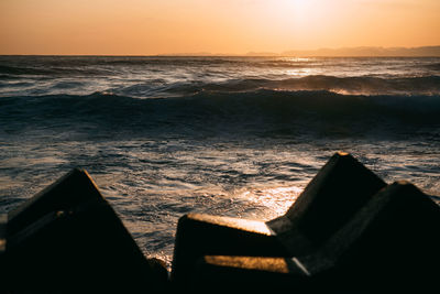 Close-up of sea against sky during sunset