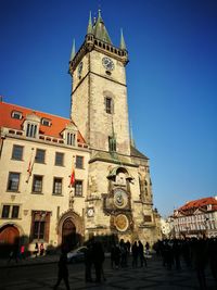 Low angle view of clock tower against blue sky