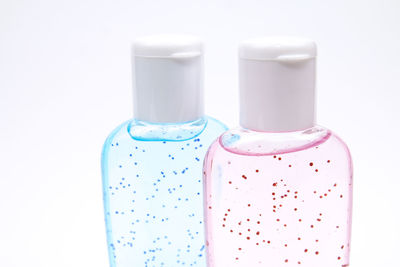 Close-up of pink bottle against white background