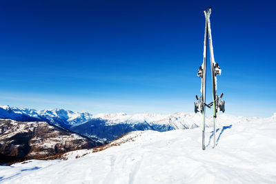 Scenic view of snowcapped mountains against blue sky