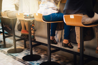 Low section of man sitting on table