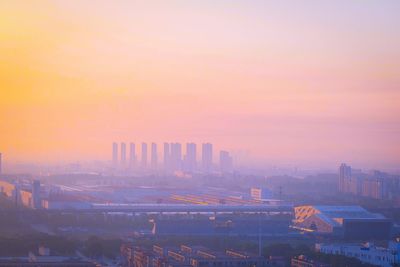 High angle view of buildings in city during sunset