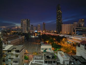 High angle view of illuminated buildings against sky at night