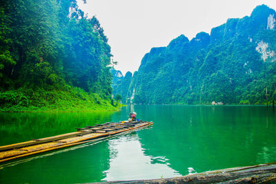 Scenic view of lake by trees against sky