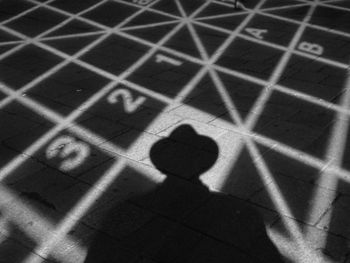 Shadow of people on tiled floor