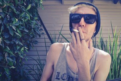 Young man smoking cigarette outdoors