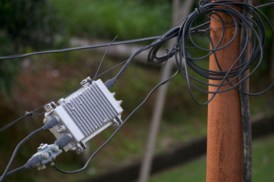 Close-up of cables hanging on pole