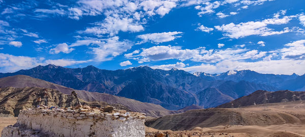 Panoramic view of landscape and mountains against blue sky