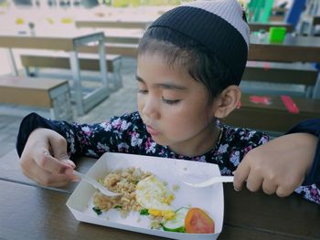 Portrait of girl holding my meal on table