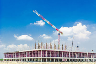 Low angle view of crane against sky