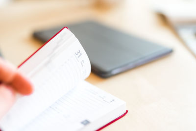 Close-up of person using laptop on table