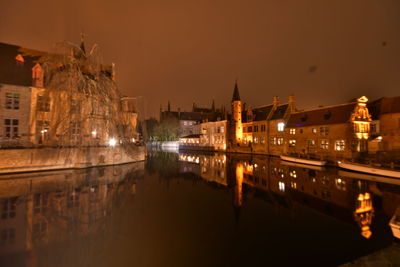 Reflection of illuminated buildings in city at night