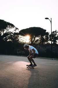 Full length of man skateboarding at playground during sunset