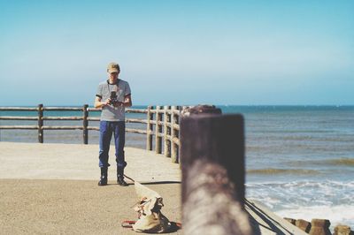 Rear view of woman walking on beach